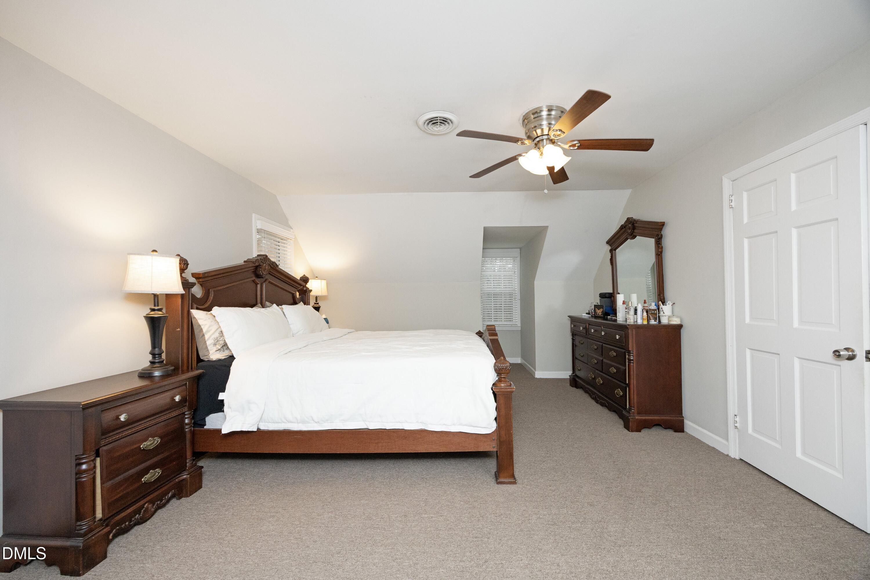 7117 Sunset Lake Road Fuquay-Varina, NC 27526 - Photo 22 of 41 a bedroom with a bed and a chandelier