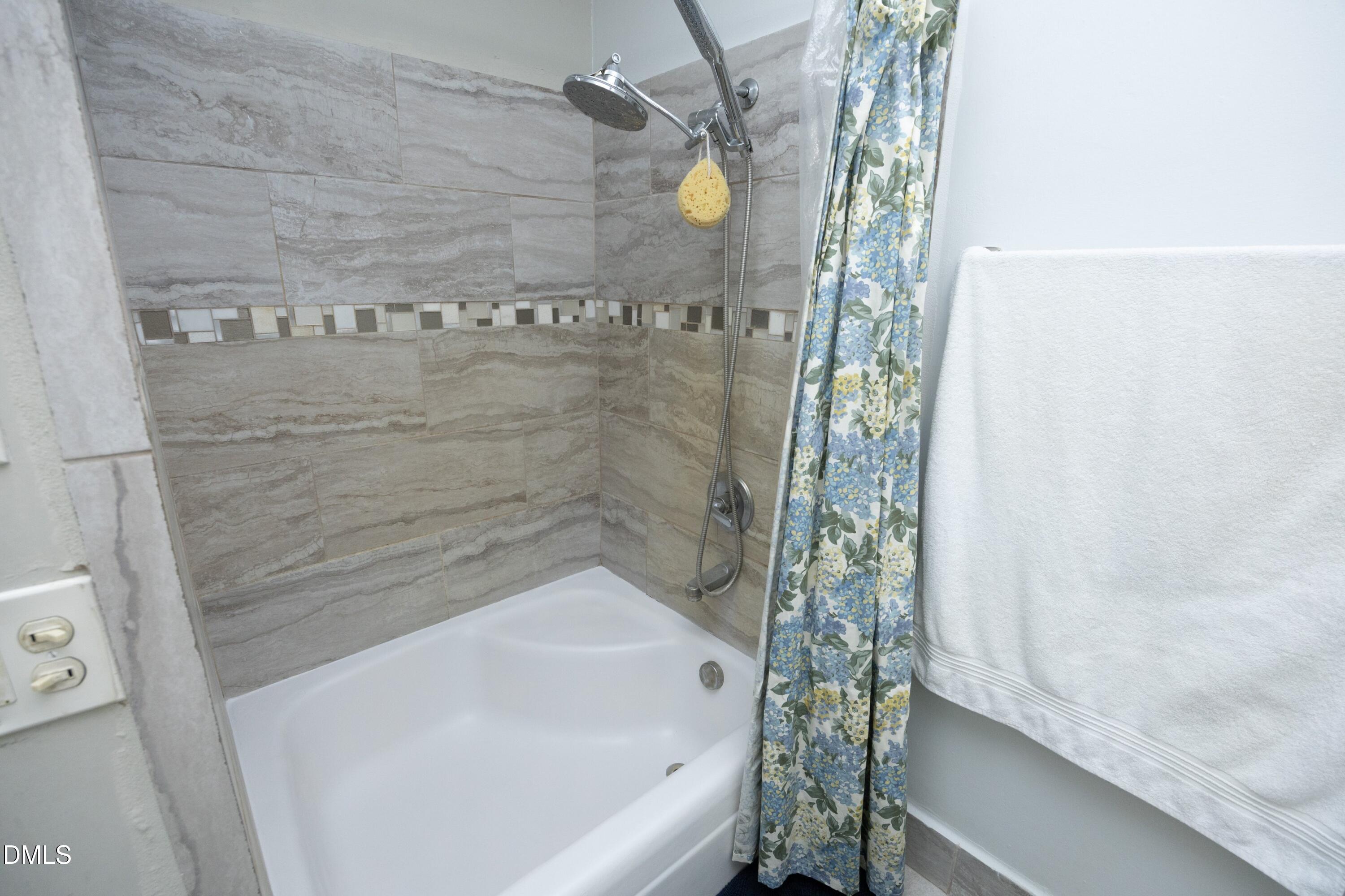 7117 Sunset Lake Road Fuquay-Varina, NC 27526 - Photo 27 of 41 a bathroom with a bathtub and shower