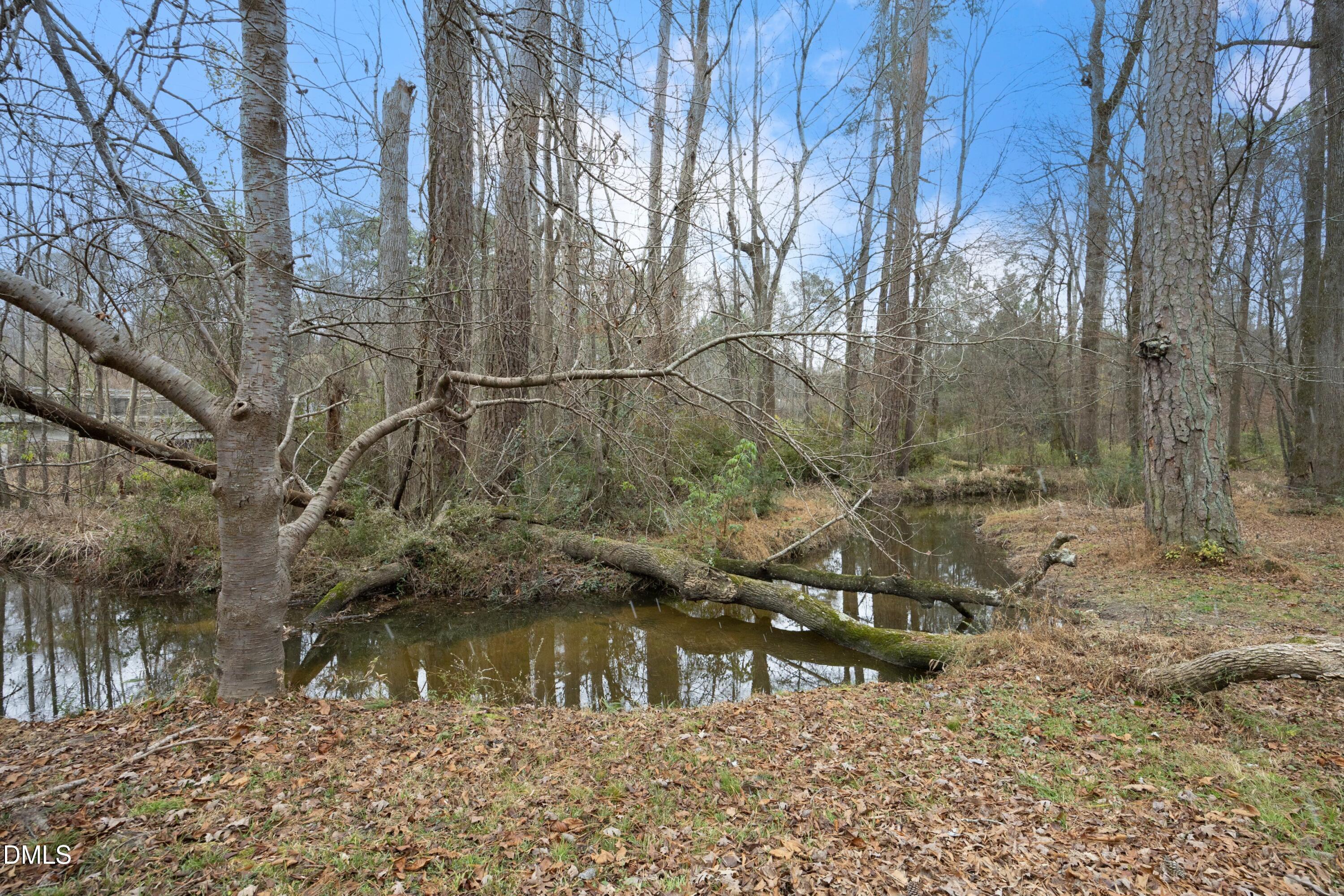 7117 Sunset Lake Road Fuquay-Varina, NC 27526 - Photo 3 of 41 a view of a lake with a yard