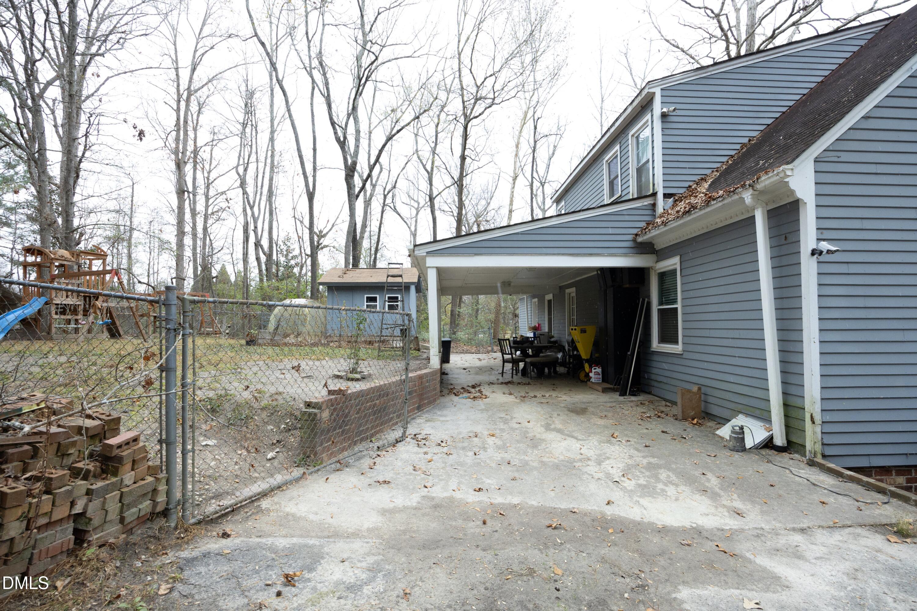 7117 Sunset Lake Road Fuquay-Varina, NC 27526 - Photo 33 of 41 a view of a house with large trees and wooden fence