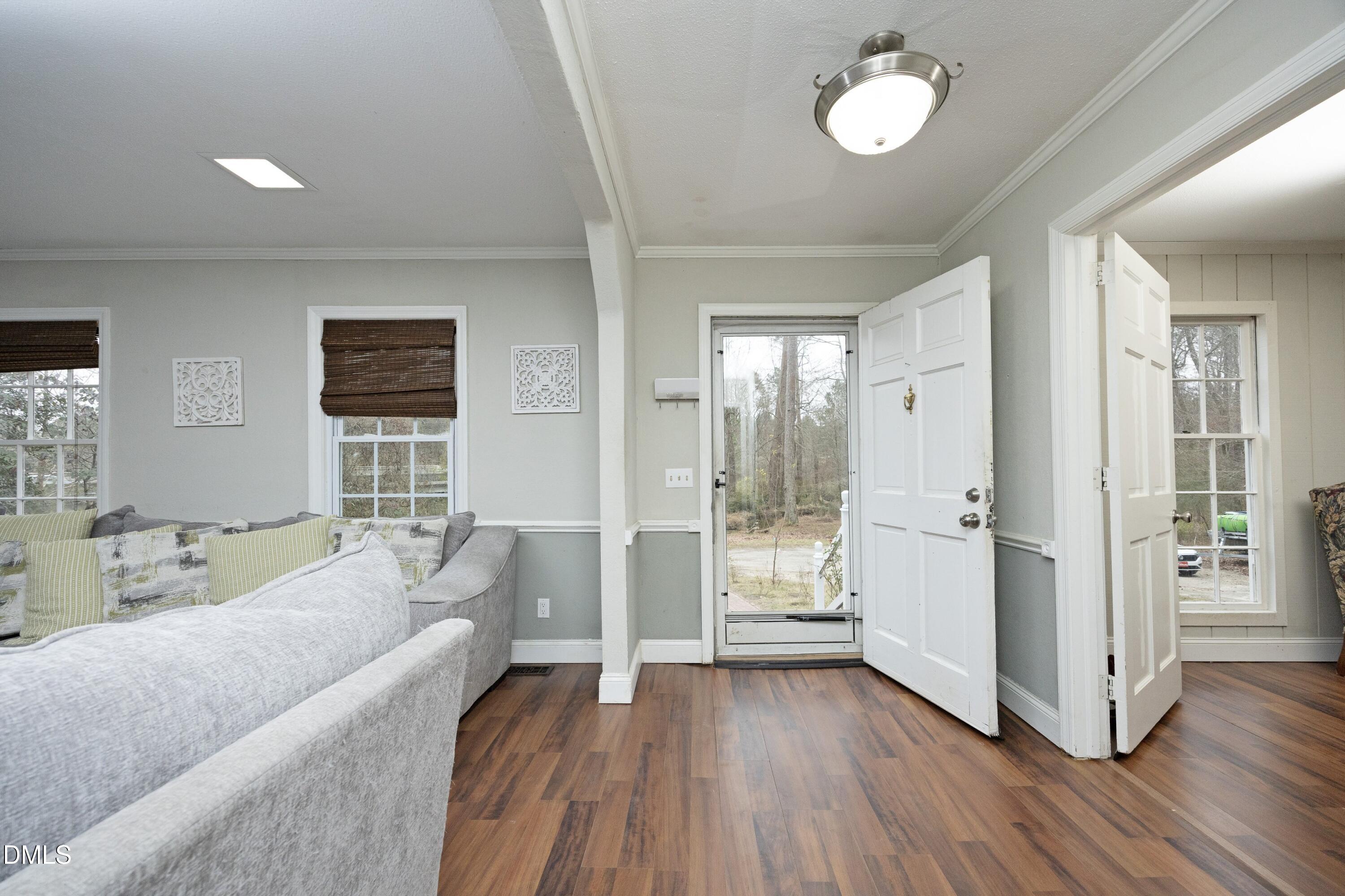 7117 Sunset Lake Road Fuquay-Varina, NC 27526 - Photo 7 of 41 a living room with furniture and a wooden floor