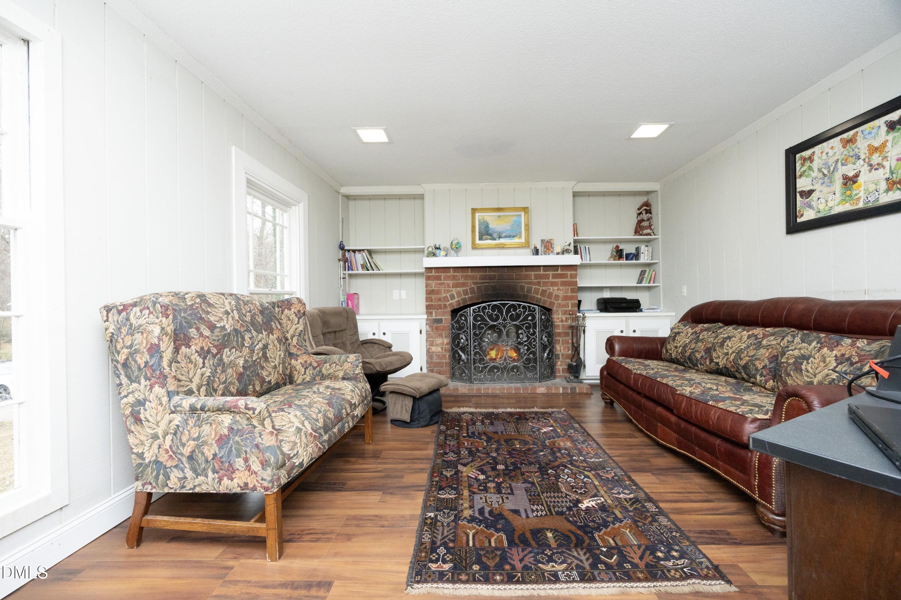 7117 Sunset Lake Road Fuquay-Varina, NC 27526 - Photo 8 of 41 a living room with furniture and a fireplace