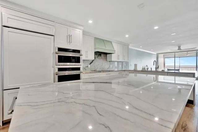 a view of a kitchen with cabinets and wooden floor