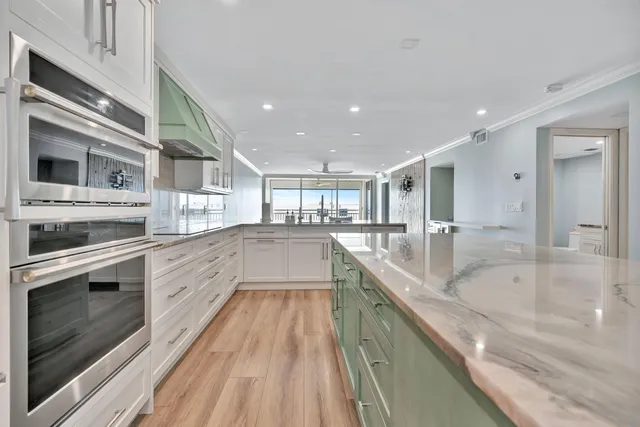 a kitchen with stainless steel appliances granite countertop a stove and a refrigerator