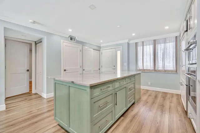 wooden floor chandelier and windows in a room