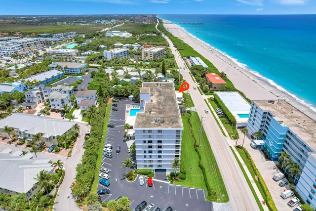 a view of a house with a yard and potted plants
