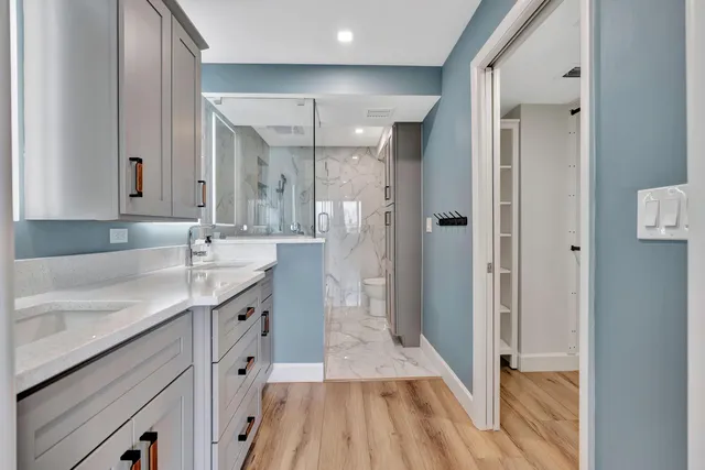 a living room with furniture a chandelier and a flat screen tv