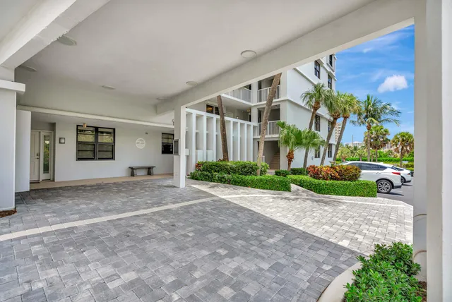 a kitchen with kitchen island granite countertop a sink and wooden floors