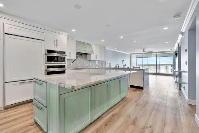 a view of kitchen with stainless steel appliances refrigerator oven and cabinets