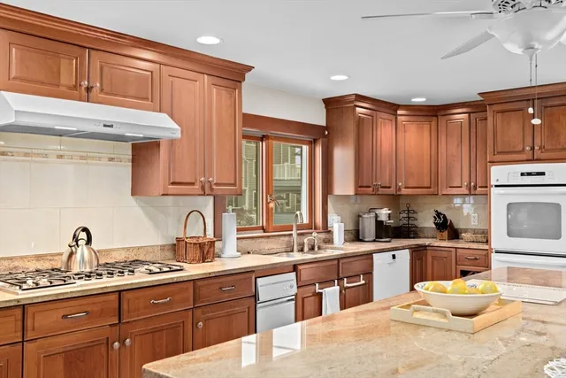 a kitchen with stainless steel appliances a sink stove and cabinets