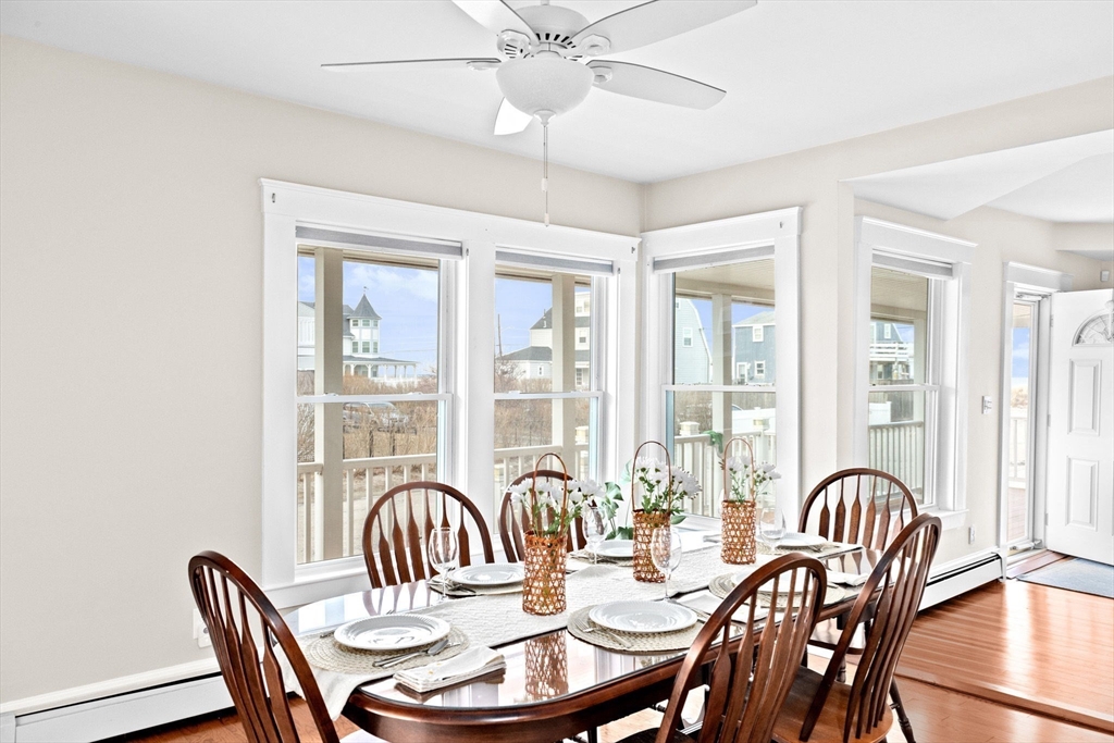 24 Warren Street Hull, MA 02045 - Photo 12 of 41 a dining room with furniture a chandelier and wooden floor