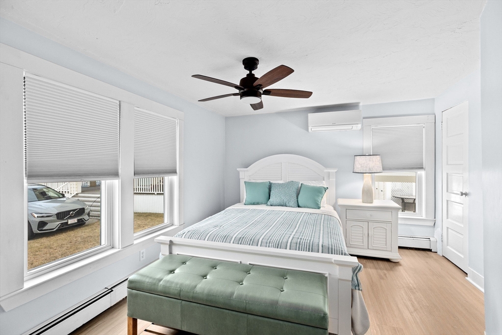 24 Warren Street Hull, MA 02045 - Photo 14 of 41 a bedroom with a bed and a chandelier