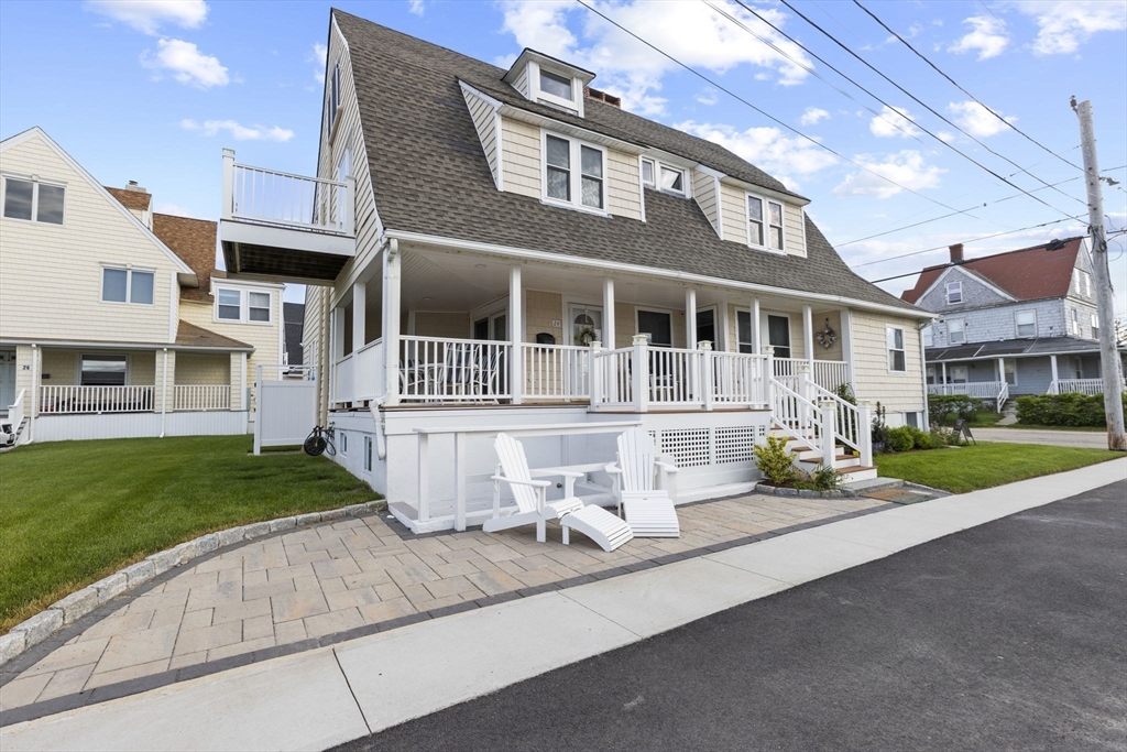 24 Warren Street Hull, MA 02045 - Photo 25 of 41 a front view of a house with a yard and garage