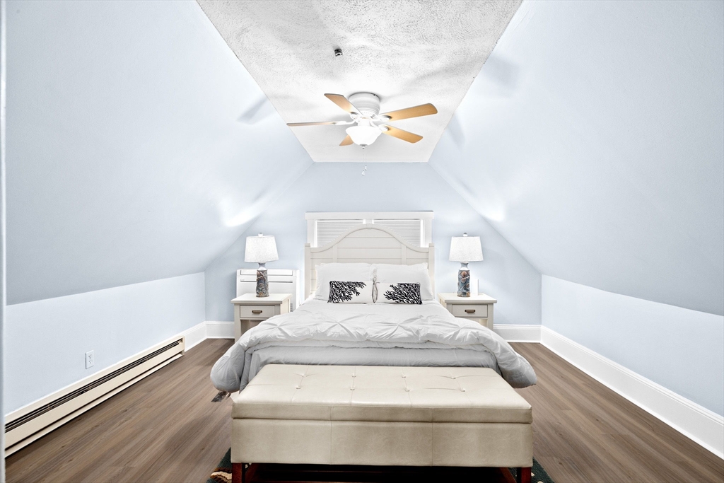 24 Warren Street Hull, MA 02045 - Photo 30 of 41 a bedroom with a bed and a chandelier