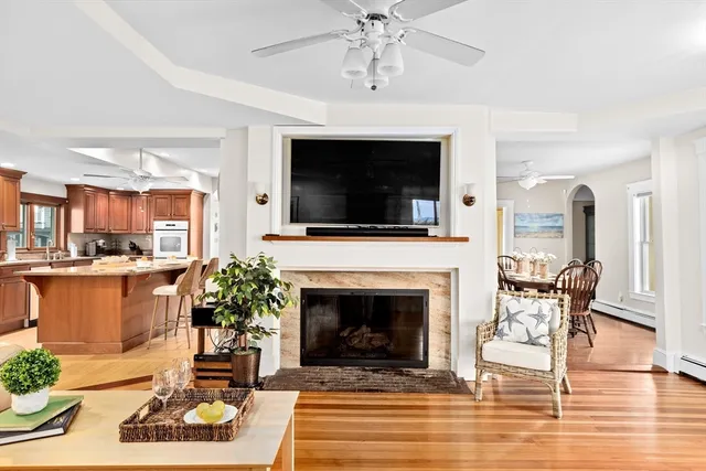 a living room with furniture a flat screen tv and a fireplace