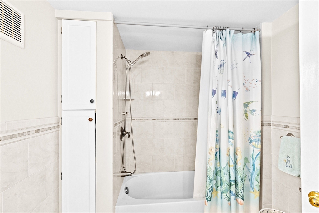 24 Warren Street Hull, MA 02045 - Photo 31 of 41 a bathroom with a shower and a glass door