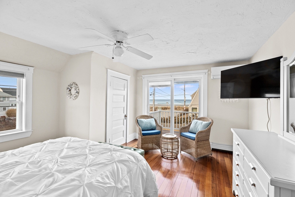 24 Warren Street Hull, MA 02045 - Photo 33 of 41 a bedroom with a bed and a flat screen tv