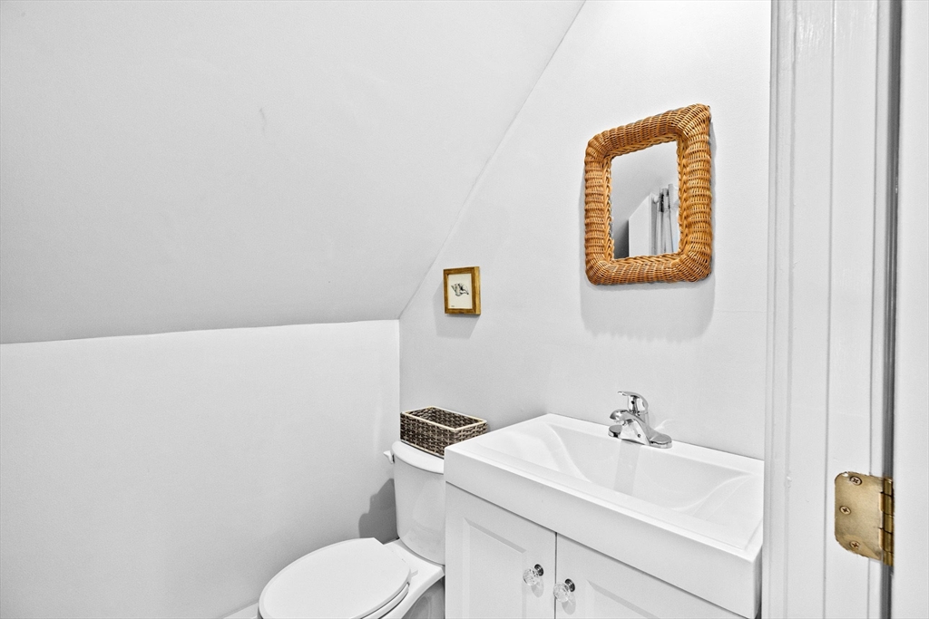 24 Warren Street Hull, MA 02045 - Photo 38 of 41 a bathroom with a toilet sink vanity and mirror