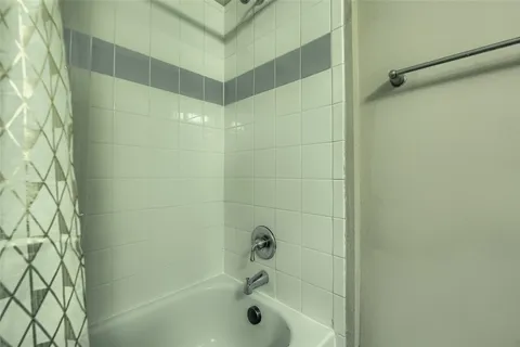 a bathroom with a granite countertop sink shower and a mirror