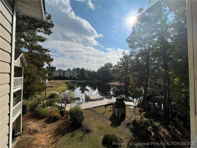 a view of a patio with table and chairs and couches with wooden floor