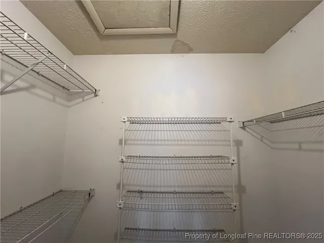 a view of a livingroom with a fireplace and window