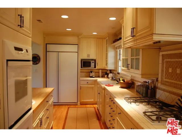 a kitchen with refrigerator and cabinets