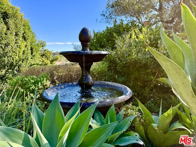 a view of a water fountain in front of a house