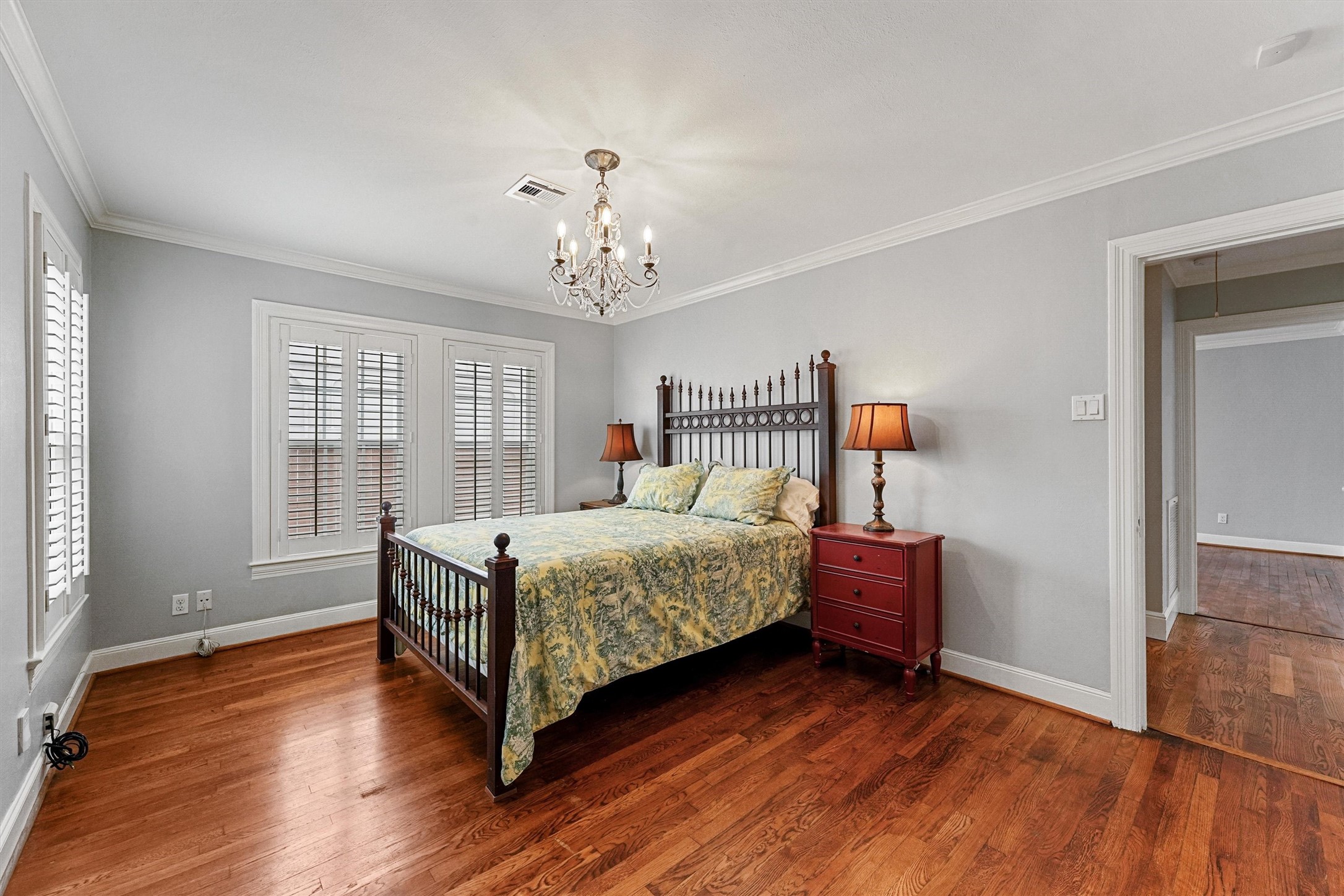 6645 Fairfield Street Houston, TX 77023 - Photo 12 of 28 a bedroom with a bed wooden floor and window