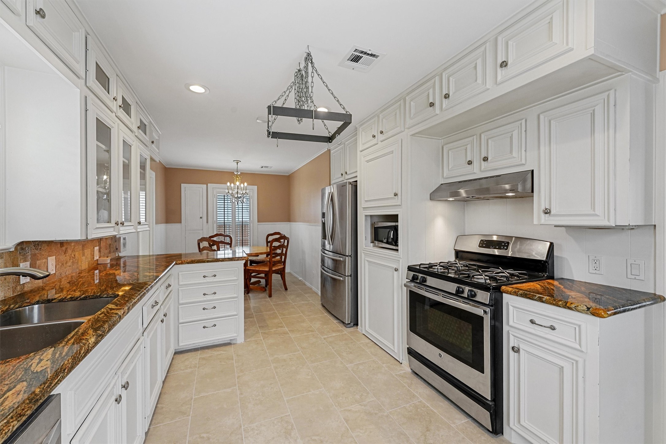 6645 Fairfield Street Houston, TX 77023 - Photo 17 of 28 a kitchen with granite countertop a sink stainless steel appliances and cabinets