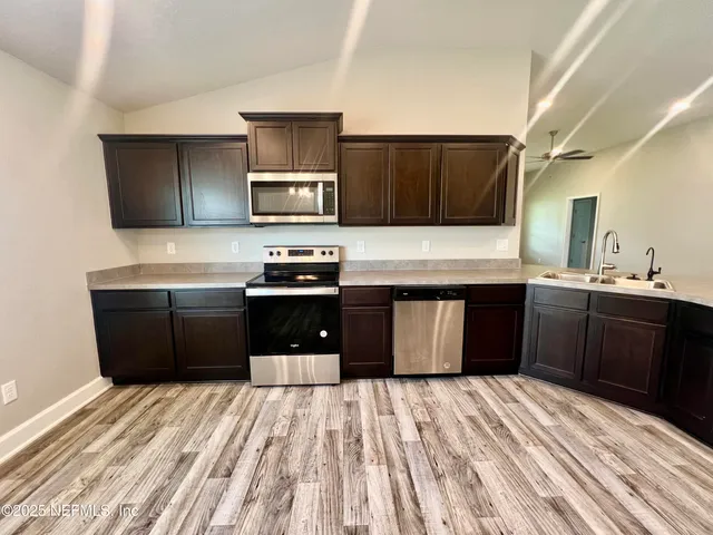 a front view of house with yard and green space