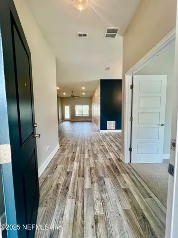 a view of a room with wooden floor cabinets and a window
