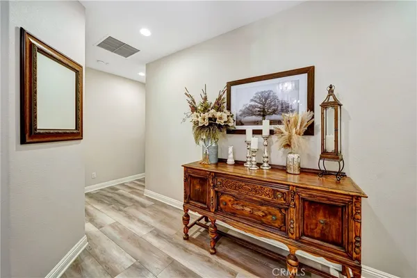 a room with lots of books and a large tree
