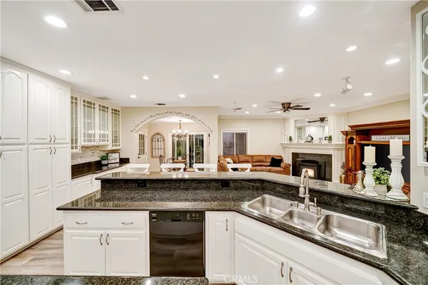 a bathroom with a granite countertop sink a toilet and a bathtub