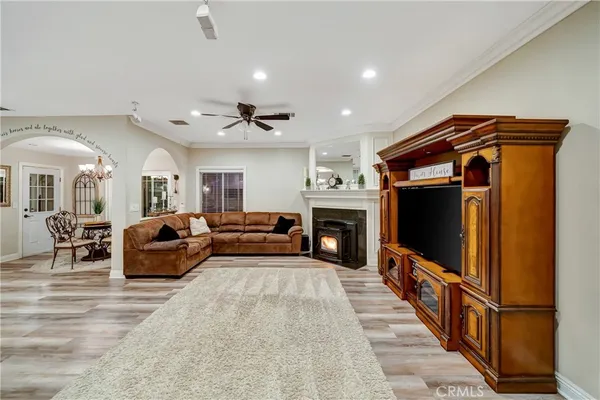 a spacious bedroom with a bed and a flat tv screen on dresser