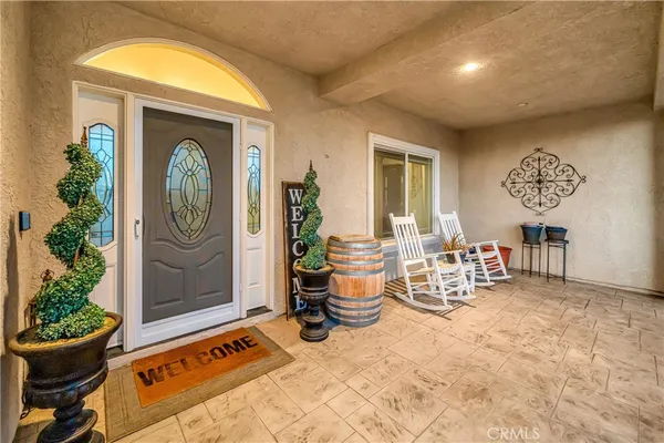 a view of a dining room with furniture and a chandelier