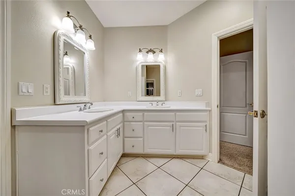 a kitchen with stainless steel appliances kitchen island granite countertop a refrigerator a stove and a sink with wooden floor