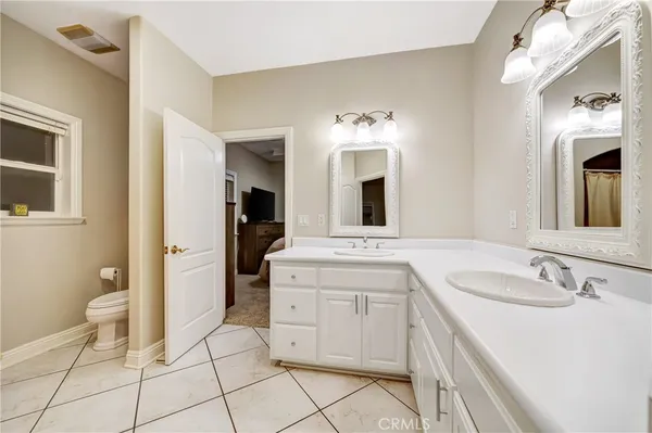 a living room with furniture a flat screen tv and kitchen view