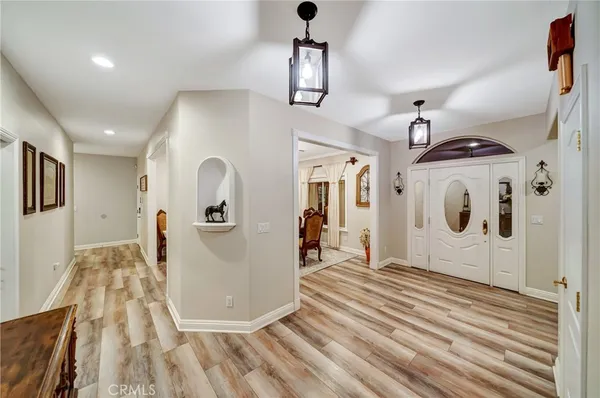 a view of a dining room with furniture and chandelier