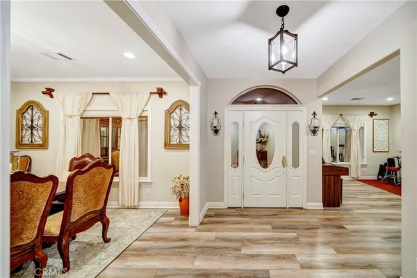 a large kitchen with stainless steel appliances granite countertop a stove a sink a refrigerator white cabinets and a granite counter tops