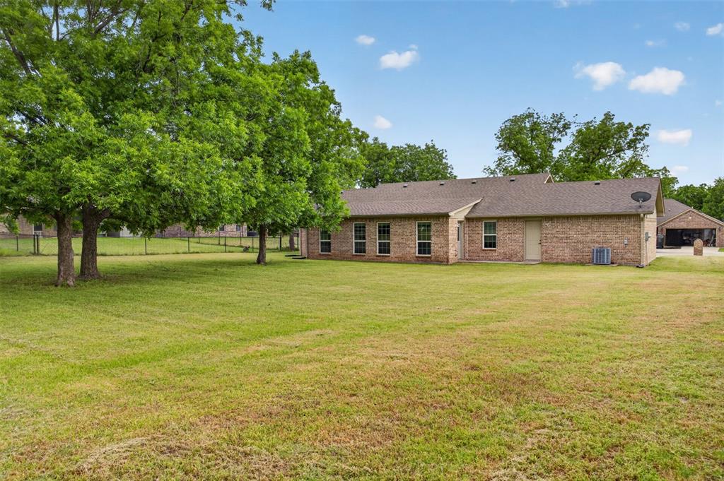 505 East 5th Street Springtown, TX 76082 - Photo 36 of 39 a front view of house with yard and green space