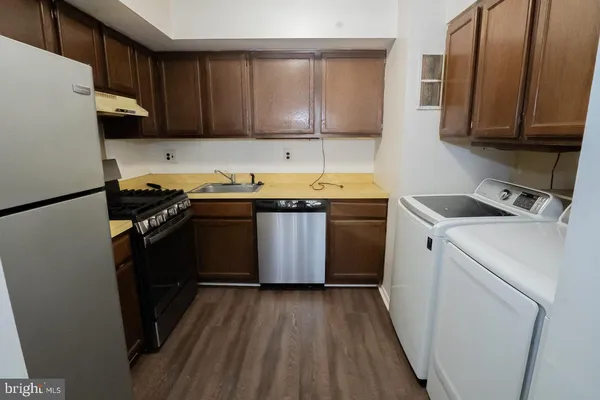 a kitchen with a sink stove and refrigerator