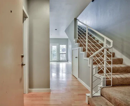 a view of an entryway with wooden floor