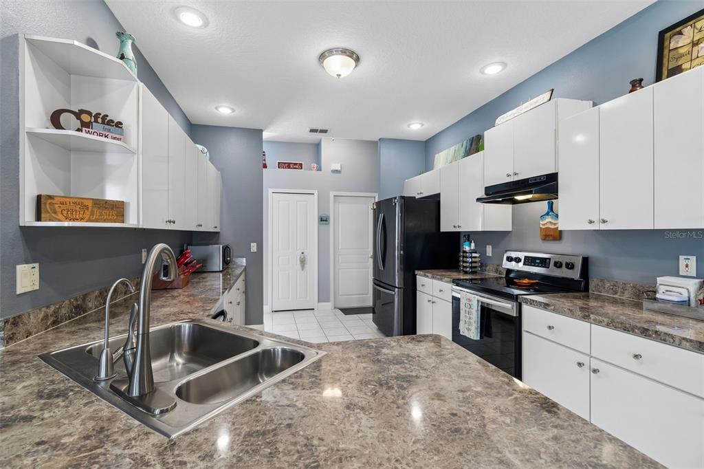11017 Audie Brook Drive Spring Hill, FL 34608 - Photo 26 of 67 a kitchen with stainless steel appliances granite countertop a sink and a stove