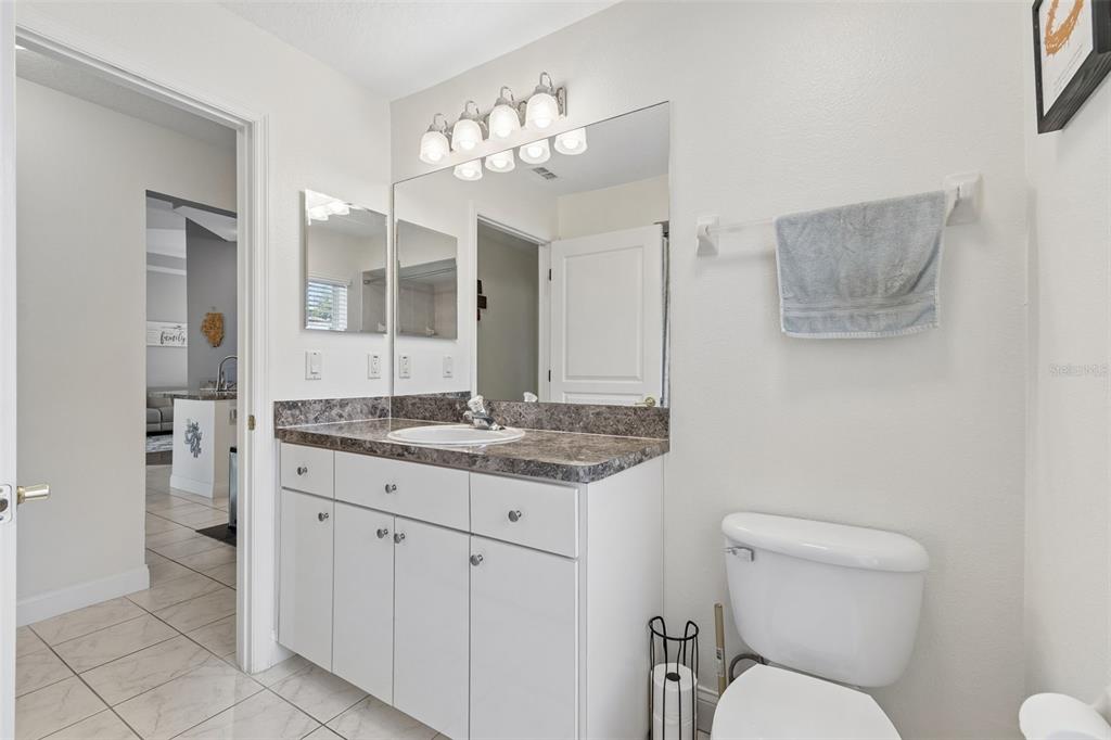 11017 Audie Brook Drive Spring Hill, FL 34608 - Photo 33 of 67 a bathroom with a granite countertop toilet sink and mirror