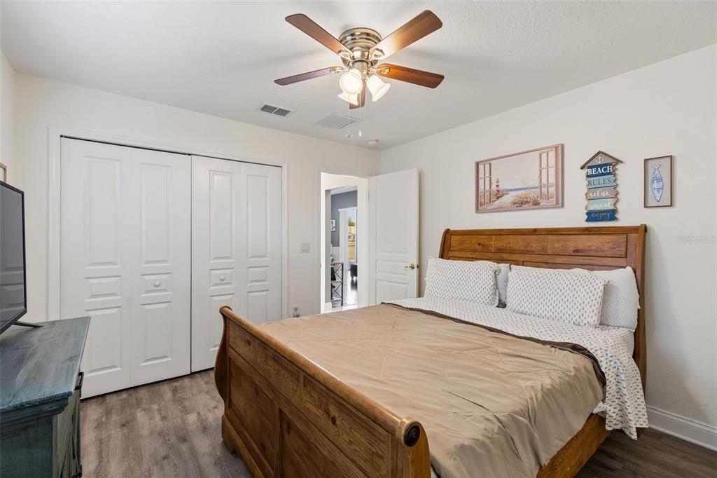 11017 Audie Brook Drive Spring Hill, FL 34608 - Photo 35 of 67 a bedroom with a bed and a chandelier