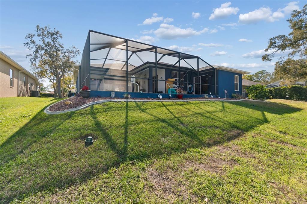 11017 Audie Brook Drive Spring Hill, FL 34608 - Photo 58 of 67 a view of a house with a yard