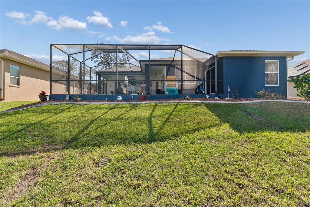 11017 Audie Brook Drive Spring Hill, FL 34608 - Photo 59 of 67 a view of a house with a yard and a patio