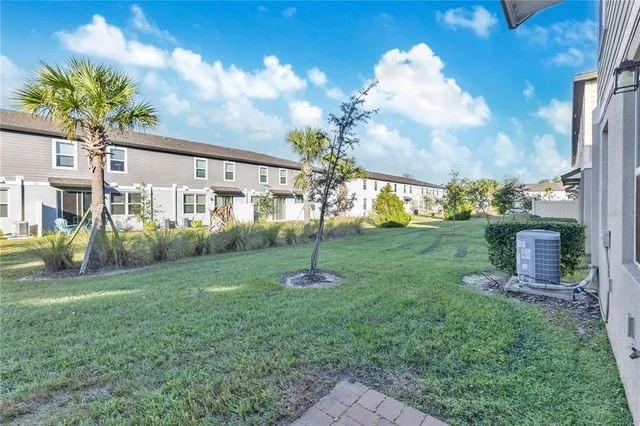a view of a house with backyard and porch
