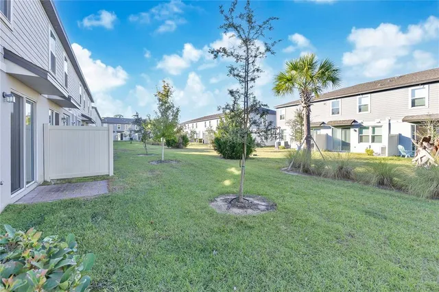 a view of a roof deck with dining table and chairs