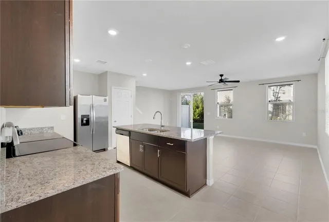 a kitchen with stainless steel appliances granite countertop a sink and stove